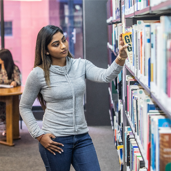 A Regent Business School student browsing the library