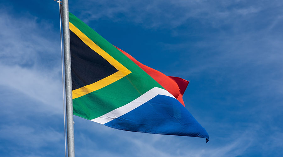 south-african-flag-against-clean-blue-sky
