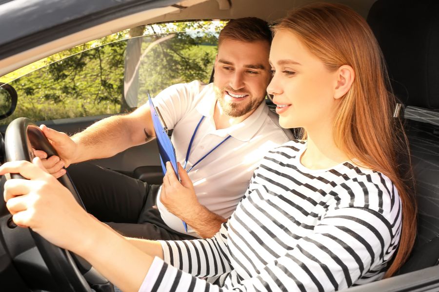 student listening to driving instructor after taking driver's licence test