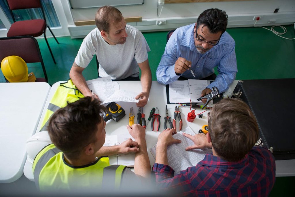 Electrician instructor sitting with students