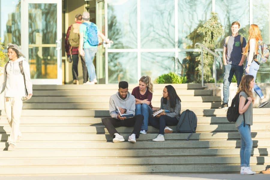 friends sitting together at university campus