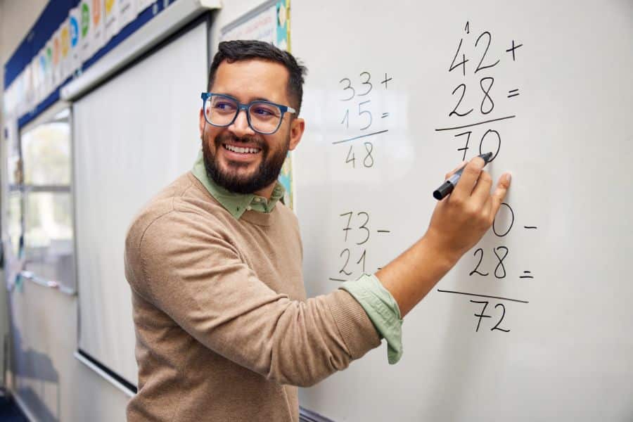 male teacher teaching after completing pgce