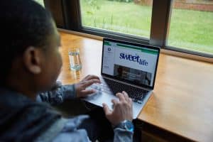Student preparing NSFAS appeal documents at a desk with laptop