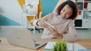 Student using a smartphone to contact NSFAS for help with funding queries