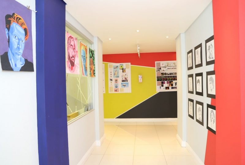 A colourful blue, lime green, red and black designed wall leading into a passageway on AAA School of Advertising campus