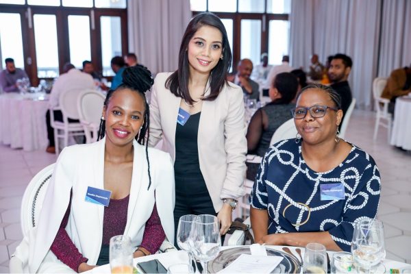 Three Richfield Graduate Institute of Technology female students at an evening event wearing smart clothes
